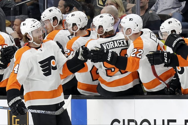 Flyers center Sean Couturier shakes hands with the bench after a goal during the second period of an NHL hockey game against the Vegas Golden Knights Sunday, Feb. 11, 2018, in Las Vegas.