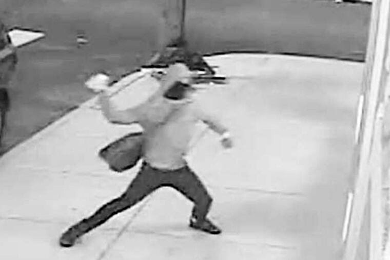 A masked vandal, seen here on surveillance footage, caused $2,000 worth of damage to developer Ori Feibush's Point Breeze coffee shop on Saturday morning, an attack Feibush claims was motivated by a local committee that opposes his building projects in the area. The group denies any involvement in the incident.