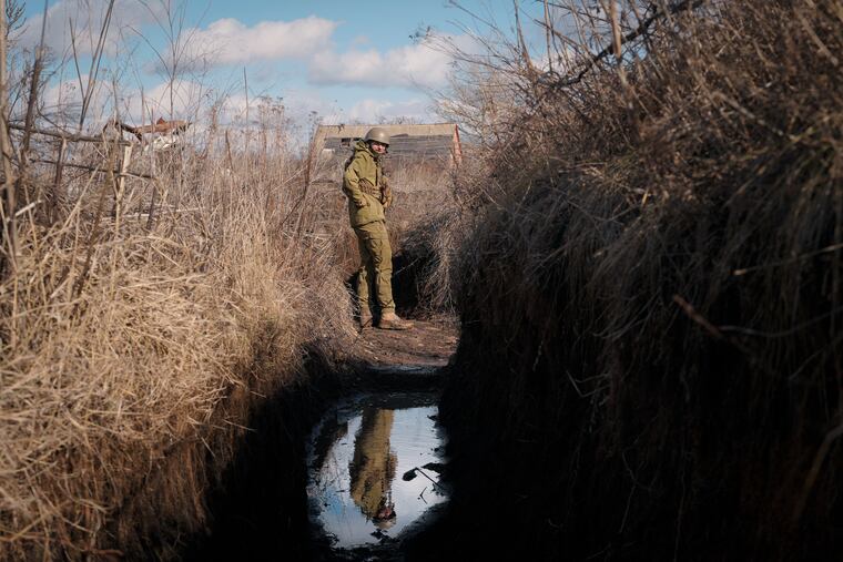 A Ukrainian serviceman pauses while walking to a frontline position outside Popasna, in the Luhansk region, eastern Ukraine, Sunday, Feb. 20, 2022. Russia extended military drills near Ukraine's northern borders Sunday amid increased fears that two days of sustained shelling along the contact line between soldiers and Russia-backed separatists in eastern Ukraine could spark an invasion. Ukraine's president appealed for a cease-fire. (AP Photo/Vadim Ghirda)