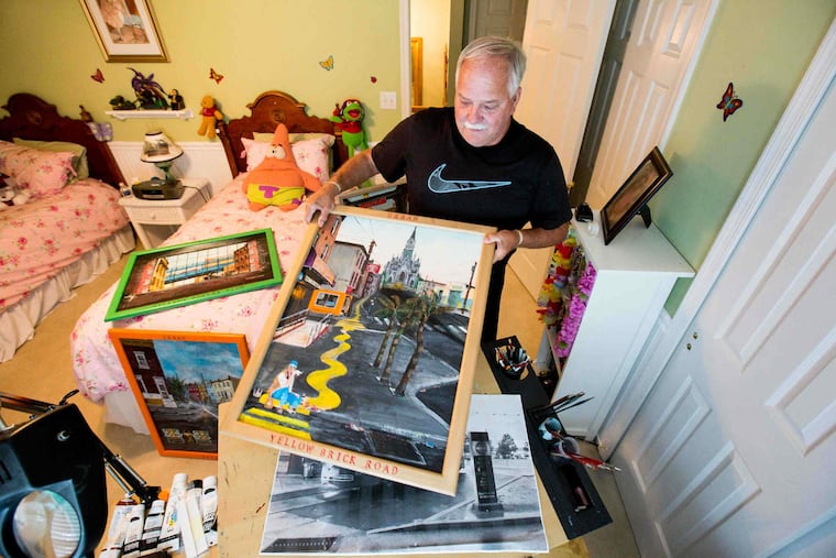 Paul Galiczynski, shown here holding his painting "Yellow Brick Road" among other works in his studio space, that doubles as his grandaughters room, in his Washington Crossing home, Wednesday, Aug. 2, 2017. Galiczynski paints contemporary city scapes of Philadelphia, he is inspired by scenes he sees when driving from job to job through the streets of Philadelphia.
