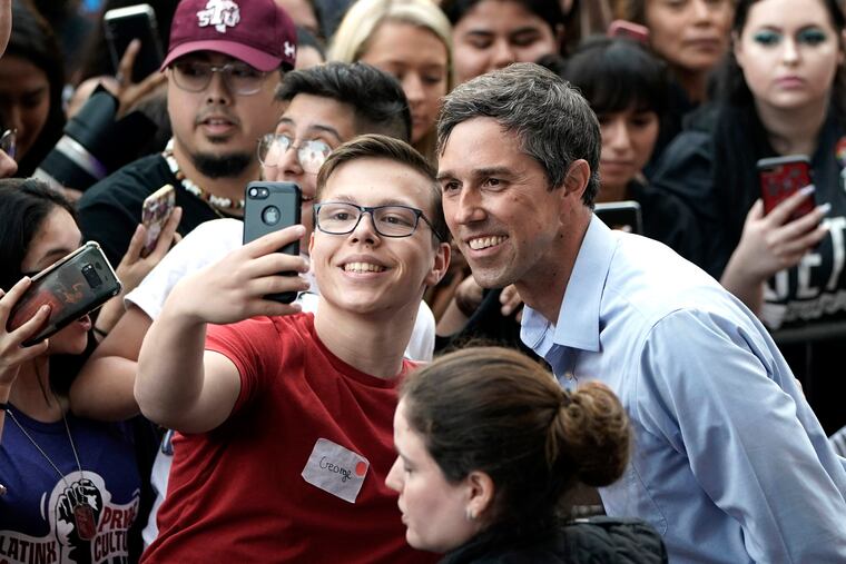 Democratic presidential candidate and former Texas congressman Beto O'Rourke, right, poses for a photograph with a supporter during his presidential campaign kickoff rally in Houston, Saturday, March 30, 2019.