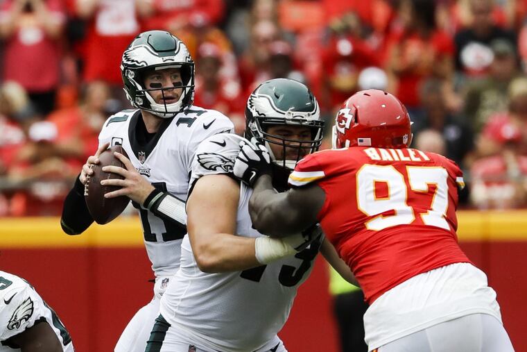 Eagles quarterback Carson Wentz is protected by guard Isaac Seumalo, who had a rough game against the Chiefs.