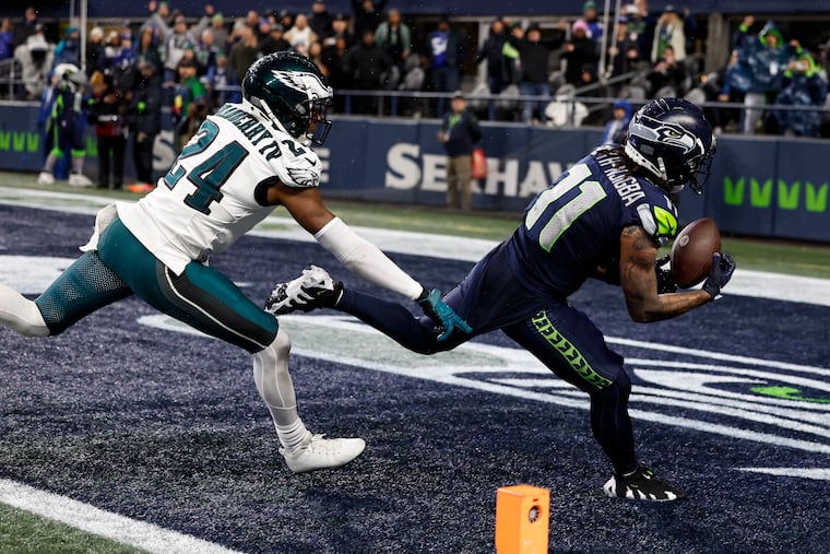 Seahawks wide receiver Jaxon Smith-Njigba catches the decisive touchdown pass as Eagles cornerback James Bradberry defends late in the fourth quarter Monday night.