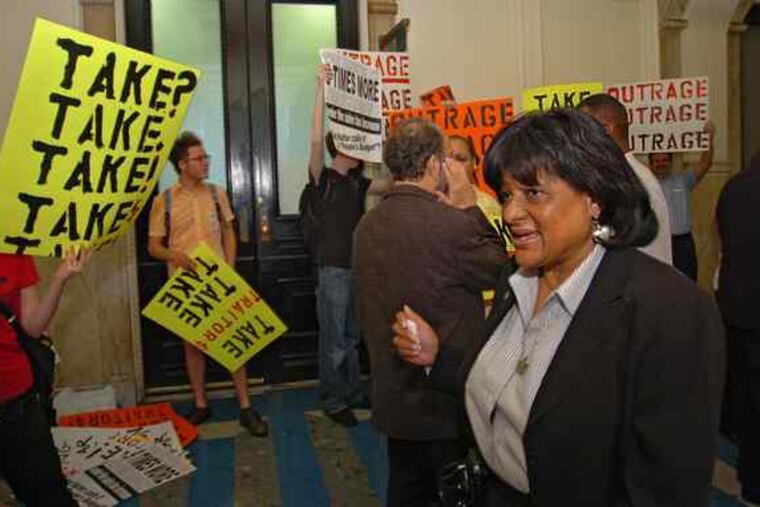 City Councilwoman Jannie Blackwell passes members of the Coalition for Essential Services who were outside Council chambers to protest the budget proposal that Council and Mayor Nutter agreed to yesterday.