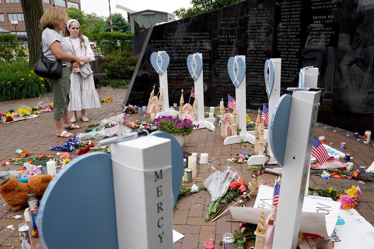 A memorial for those killed and wounded in Monday's Fourth of July mass shooting at a veterans memorial in Highland Park, Ill.