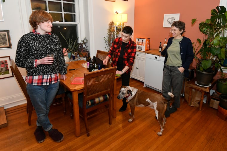From left to right, best friends Lizzy Seitel, Rachel Neuschatz and Rachel Luban prepare a house dinner in a kitchen of their shared West Mt Airy home. The Rachels co-parent the dog.