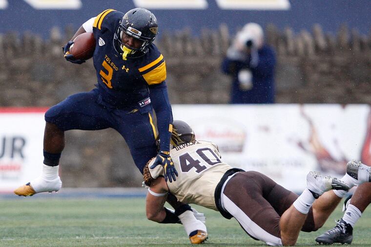 Toledo Rockets running back Kareem Hunt (3) tries to break a tackle from Western Michigan Broncos linebacker Grant DePalma (40) during the first quarter at Glass Bowl.