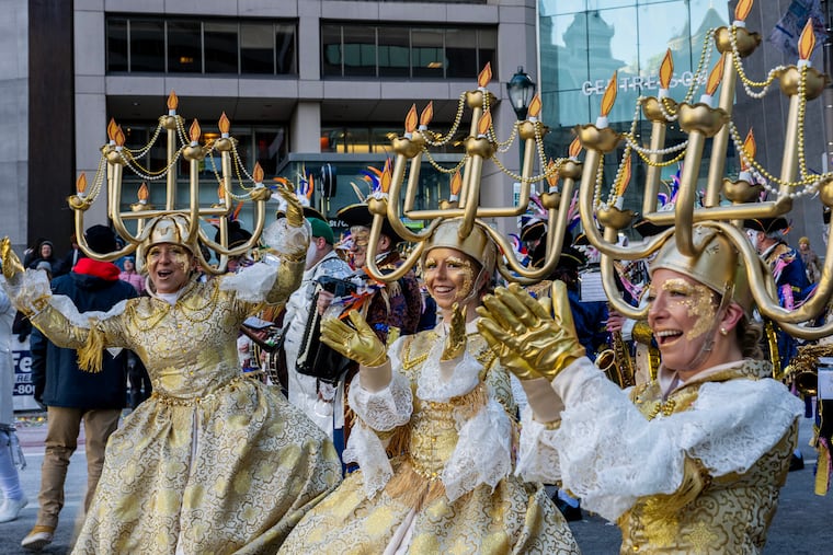 Durning String Band dancers with candelabra headpieces for their “Be Our Guest” theme prepare to march the Mummers Parade Thursday, Jan. 1, 2026, after the String Band competition was suspended because of high winds that destroyed props and caused injuries during morning setup. The bands still marched and played their music, but did not carry props, and would not judged.