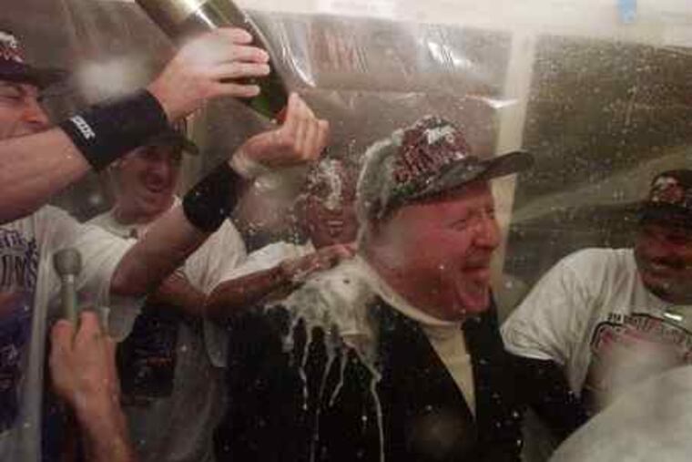 George Steinbrenner was showered with champagne after the New York Yankees won the World Series in 1998. The Yankees won seven World Series in his tenure. The owner is remembered for his tenacity. Sports, E1.