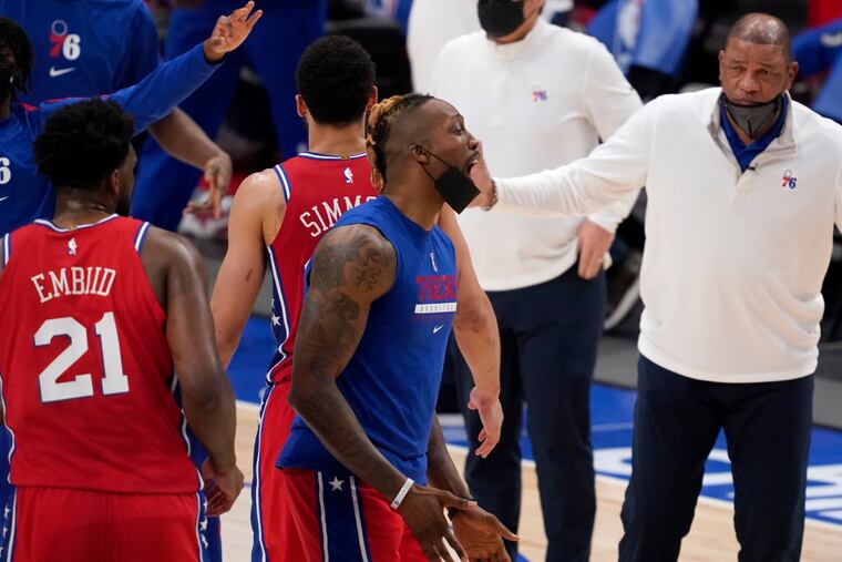 Philadelphia 76ers' Joel Embiid (21), Dwight Howard (center) and head coach Doc Rivers celebrate during a timeout in the second half of Monday's against Dallas.