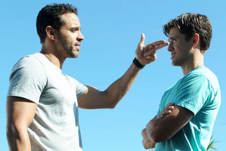 Daniel Sunjata (left) makes a point to Aaron Tveit, both playing undercover FBI agents sharing surf, sand and a tense house.