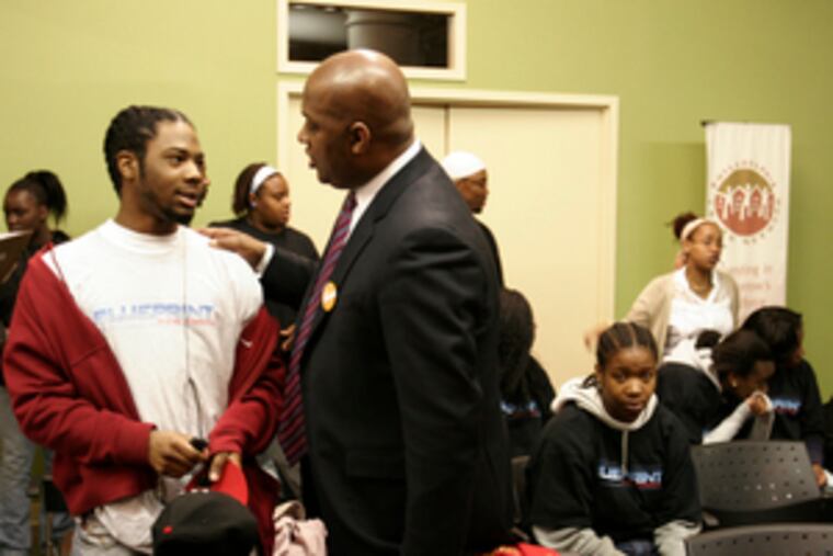 State Rep. Dwight Evans (right) talks with Lionel Parks, 17, after pledging $820,000 in state funding to the Philadelphia Youth Network. The money will help make up a shortage in funds to hire youths for summer jobs. He challenged other agencies to raise another $480,000.