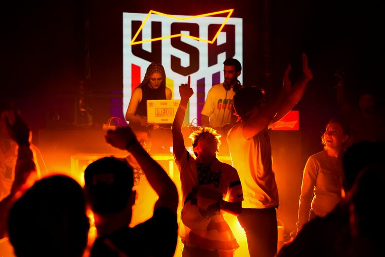 People dance during an official U.S. Soccer fan party in Doha.