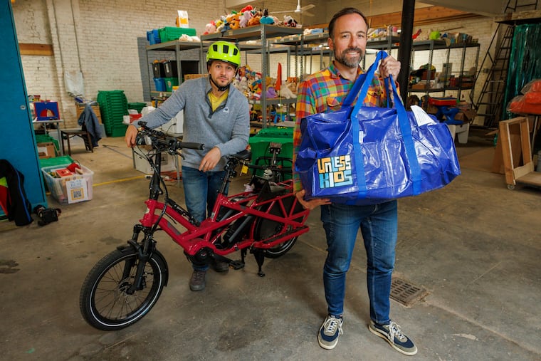 Unless Kids cofounders Nic Esposito (right) and Blake Carroll load up an electric cargo bike that Carroll will use to deliver toys to one of the company's customers.