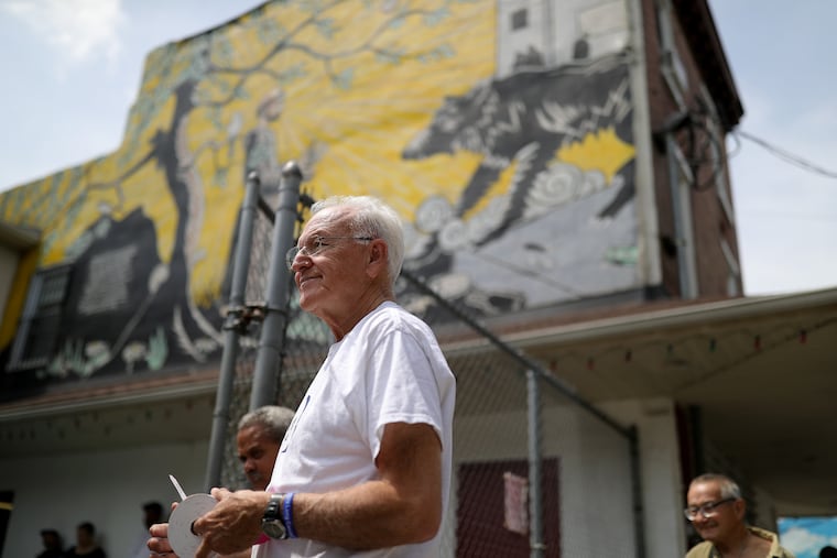 Fr. Michael Duffy hangs out food tickets for lunch outside the St. Francis Inn in Philadelphia, PA on June 8, 2018.