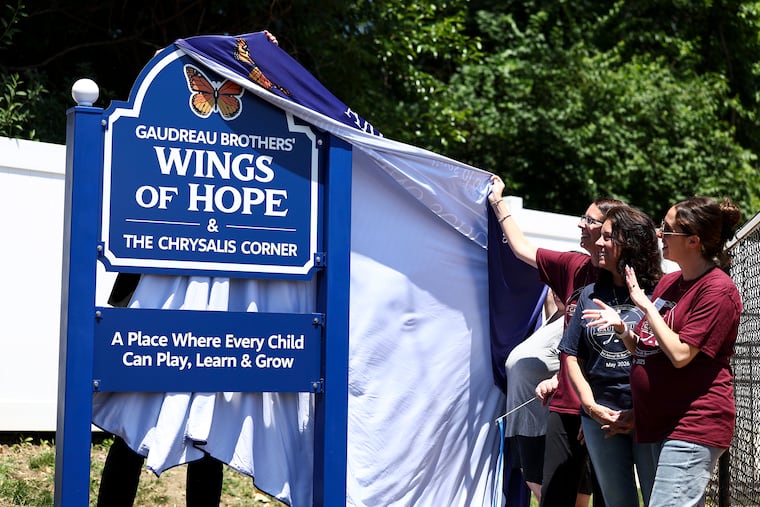 The Gaudreau family unveils new signage during a ceremony and ribbon cutting for the Gaudreau Brothers' Wings of Hope and Chrysalis Corner at Archbishop Damiano.