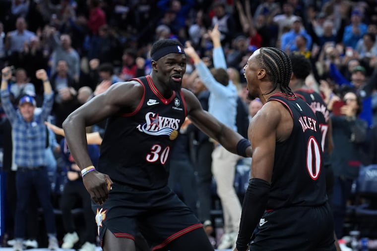 Tyrese Maxey, right, and Adem Bona celebrate after the Sixers beat the Warriors on Thursday night.