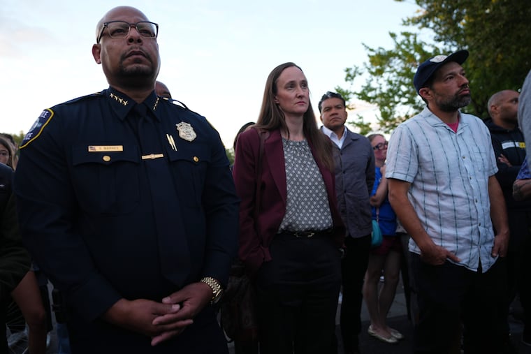 Seattle Police Chief Shon Barnes (left) and Mayor Katie Wilson attend the vigil for victims the day after a shooting at Seattle Center during the Bite of Seattle food festival, Monday, July 27, 2026, in Seattle.