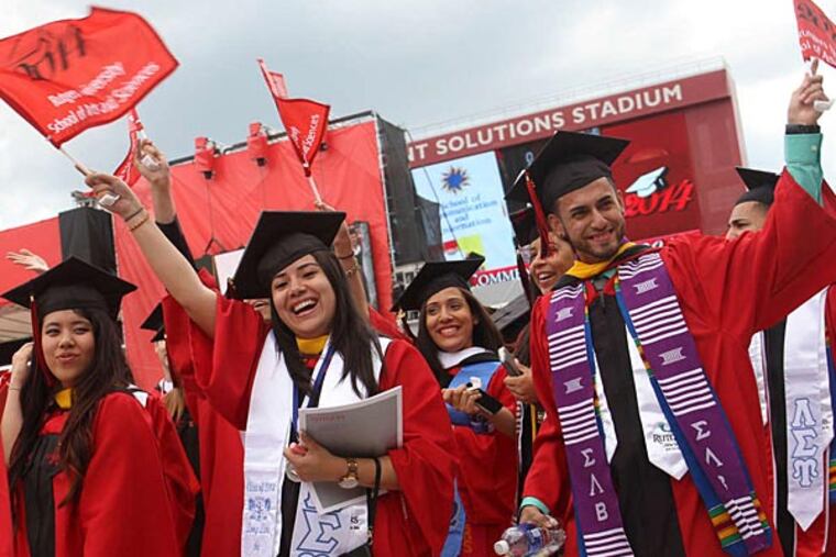Rutgers graduates celebrate in Piscataway, N.J. Fellow student Eric LeGrand, a paralyzed former football player, also spoke. JASON TOWLEN / (Somerville, N.J.) Home News Tribune