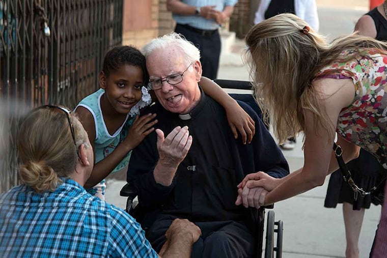 The Rev. Michael Doyle greeted by from (from left) William Butler, Kieshiya Davis, and Ronja Butler at the Camden Fireworks ribbon-cutting.