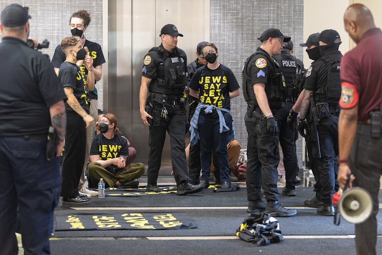 Protestors at a sit-in against the war in Gaza are arrested in the lobby of Day & Zimmermann in Philadelphia on Wednesday.