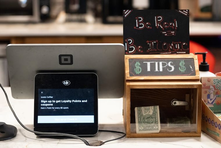 A tip box on the counter at Iconic Coffee in Hackensack, N.J. A law passed in 2025 said tipped income would no longer be taxed, but there's a limit, and workers must file for a deduction to get the money back in a tax refund.