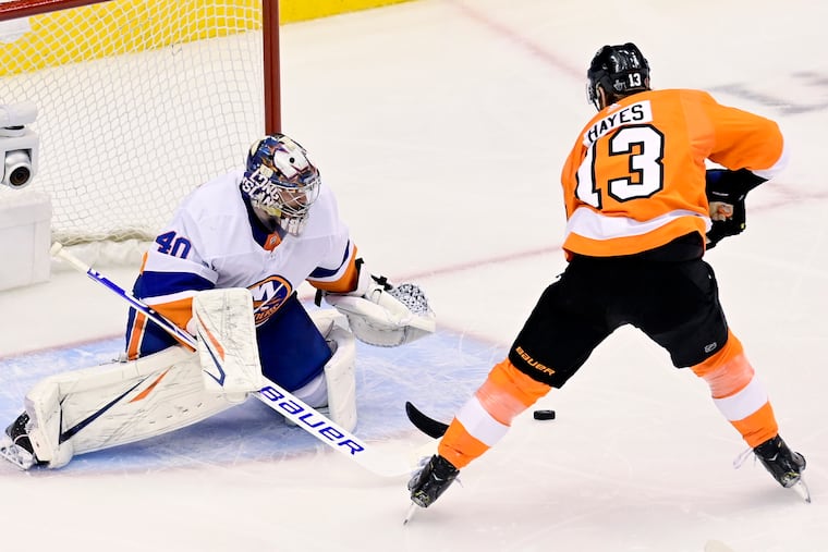 New York Islanders goaltender Semyon Varlamov braces himself as Flyers center Kevin Hayes (13) loses control of the puck on a first-period breakaway Monday.