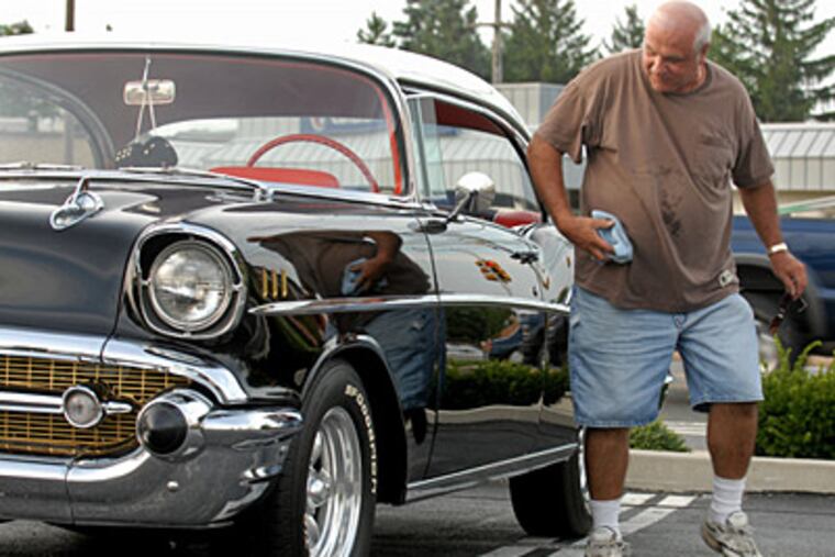 Francis Pfeil gives his 1957 Chevrolet Bel Air a once-over after parking. He bought the car used in 1966 with $325 he saved from school raffles when he was a senior at North Catholic. (Tom Gralish/Staff)