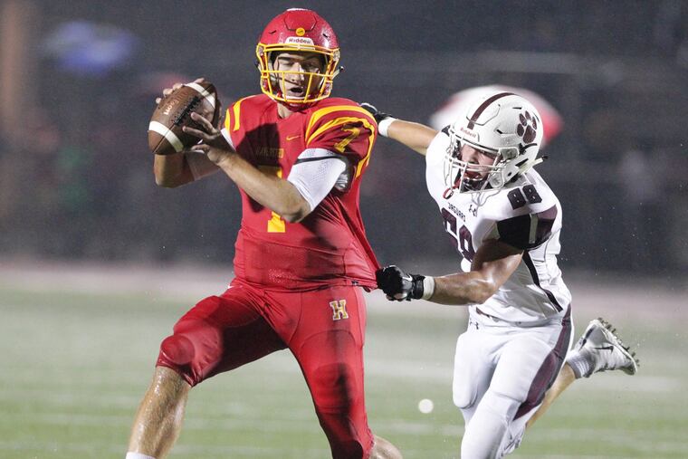 Jake Ruane, left, of Haverford tries in vain to get away from the grasp of Evan Hrivnak of Garnet Valley during the 1s quarter at Haverford High on Sept. 7, 2018.