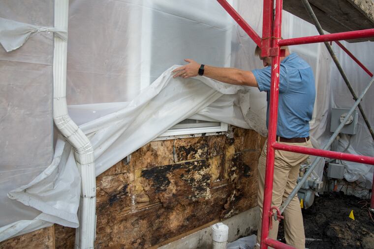 Kevin Thompson, of the home inspection company the Green Valley Group, points out damage from water intrusion at a home in the Philadelphia suburbs. Since the building boom of the mid-2000s, hundreds of homeowners in the region have experienced complications from water seeping inside the walls of their homes.