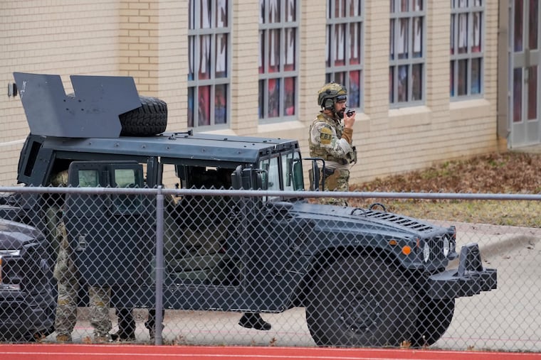Law enforcement teams stage near Congregation Beth Israel while conducting SWAT operations n Colleyville, Texas on Saturday.