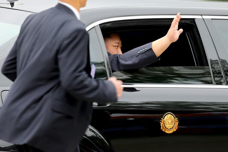 North Korean leader Kim Jong Un waves from a car after arriving by train in Dong Dang in Vietnamese border town Tuesday, Feb. 26, 2019, ahead of his second summit with U.S. President Donald Trump.