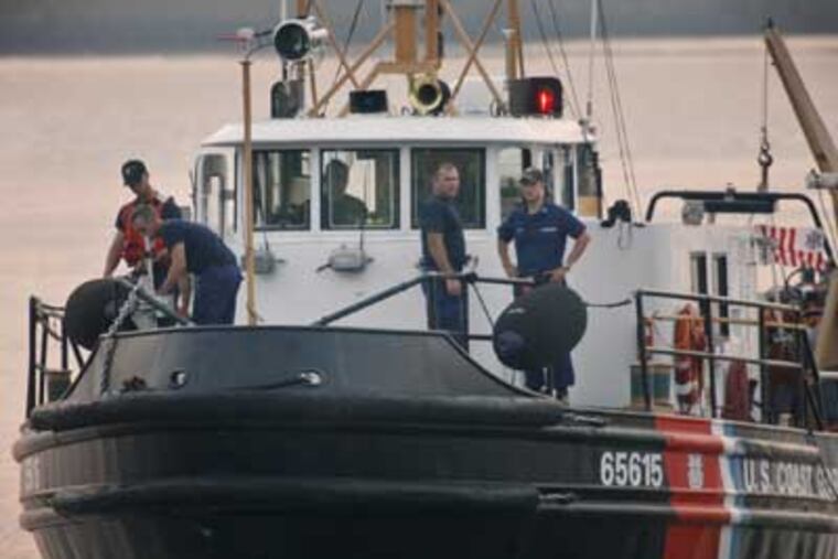 Coast Guard crews search the Delaware River in Philadelphia early today two missing passengers of the Ride the Ducks tour vehicle that collided with a barge Wednesday. (Alejandro A. Alvarez / Staff Photographer)