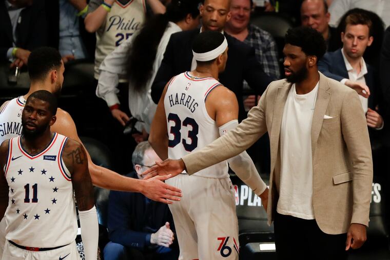 Sixers center Joel Embiid welcomes his teammates during the fourth-quarter against the Brooklyn Nets in game three of the Eastern Conference playoffs on Thursday, April 18, 2019 in Brooklyn. Embiid did not play tonight.