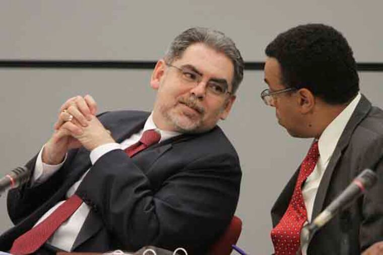 SRC Meeting---Pedro Romos chats with Wendell Pritchett as they listen to the testimonies of the speakers, Wednesday, May 15, 2013. ( Steven M. Falk / Staff Photographer )