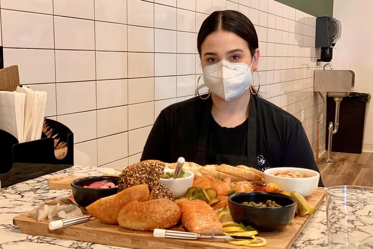 Lauren Biederman with a tray of smoked fish, bagels, and accompaniments at her shop, Biederman's Specialty Foods.