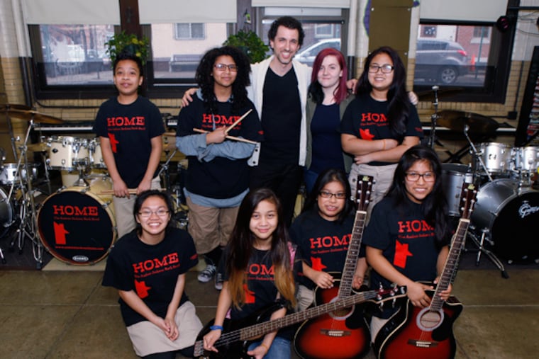 The Andrew Jackson Rock Band. From left, back row, Mario Santiago, drummer, Leila Elmanfaa, drummer, Chris Argerakis, band director, Danika Shinn, singer, and Jasmine Yedra, piano. Front row from left, Tida Hean, keyboards, Julia Yedra, bass, Maria Moreno, guitar, Ana Cancola, guitar. (MICHAEL S. WIRTZ/Staff Photographer) April 5, 2014