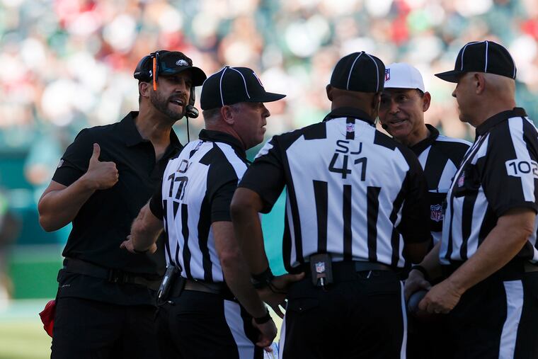 Eagles coach Nick Sirianni talks to game officials during a break on Sunday.
