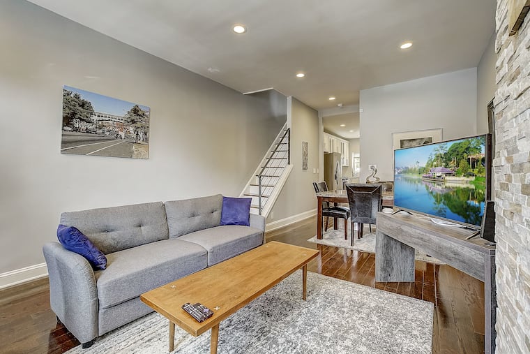The townhouse has high ceilings and large windows that let in natural light and a fenced, private patio.