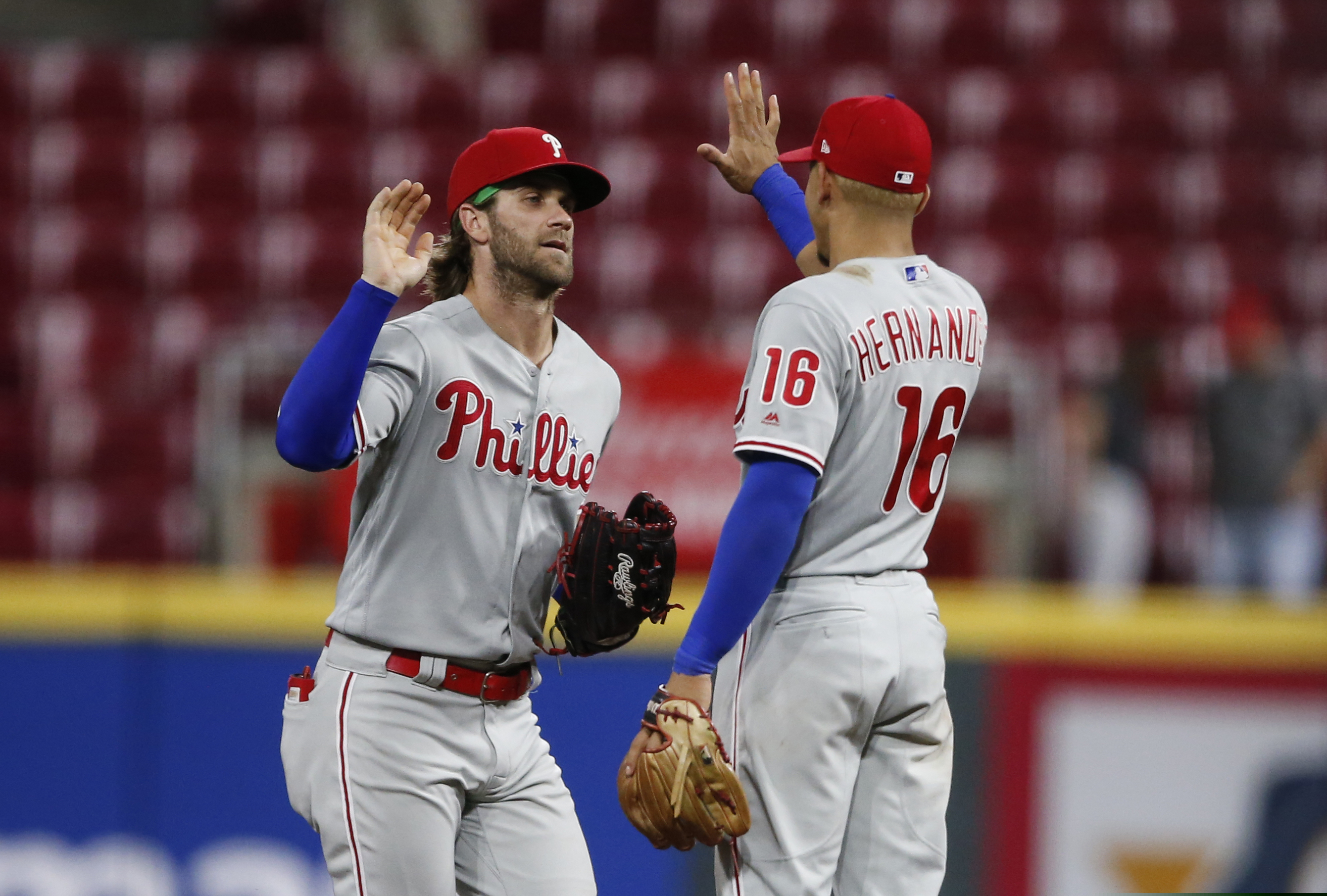 Bryce Harper, left, congratulates Cesar Hernandez after the Phillies' 6-2 victory Tuesday night in Cincinnati.