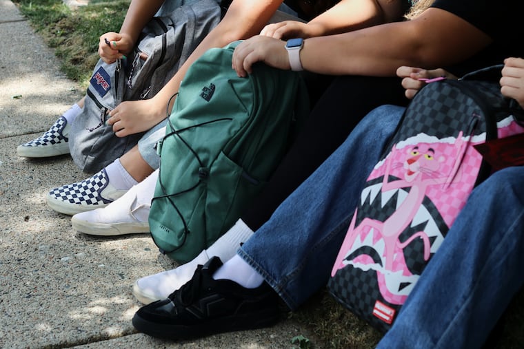 Middle school students Claire Knoth and Brockton Lozano and high school student Zoie Knoth share what is in their backpacks Friday, July 31, 2026, in Flagstaff, Ariz.