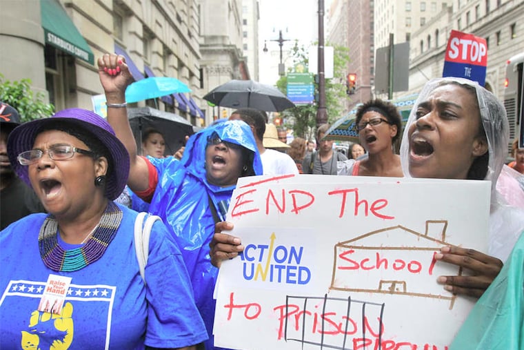 Kia Hinton (right) and others rally outside Gov. Corbett's Philadelphia office to protest inaction on a proposed cigarette tax whose proceeds would benefit Philadelphia schools.