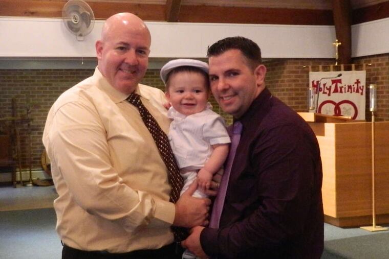 Jeff DeVault (left) and Herbie Sayles, with their son, Nathan.
