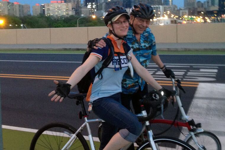 Stu Bykofsky and Alexandria Schneider, on a test run of the course for the Safe Bike Ride event, wait at a red light on the Spring Garden Bridge.
