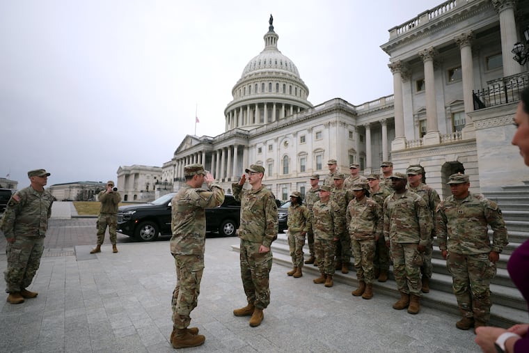 National Guard troops are seen on the East Front of the U.S. Capitol, Wednesday, Jan. 14, 2026, in Washington.