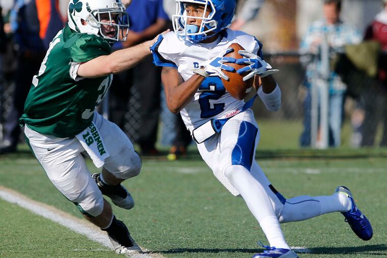 Lonnie Moore of Paul VI runs past Camden Catholic's Jeremy Nutt on Nov. 26. Separating non-public schools could negatively impact football programs in the smaller schools like Paul VI. CHARLES FOX / Staff