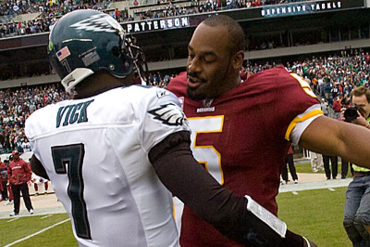 Donovan McNabb embraces Eagles quarterback Michael Vick before last month's matchup. (Clem Murray/Staff Photographer)
