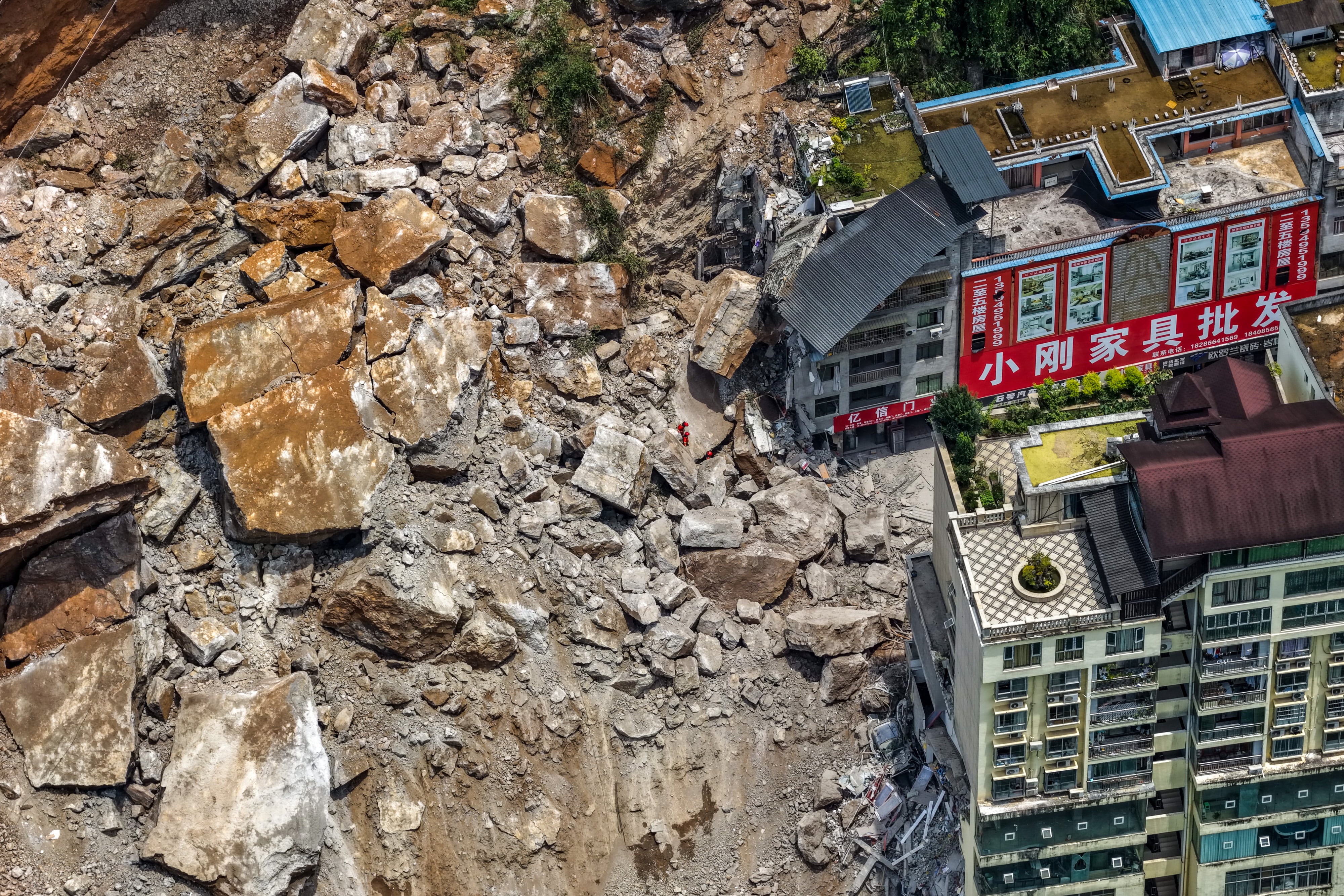 A huge landslide in southwest China buries homes and force more than 1,000 to evacuate