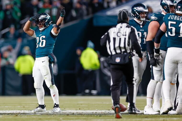 Eagles running back Saquon Barkley signals a first down after a personal foul call on the Packers during the fourth quarter of the playoff game at the Linc.