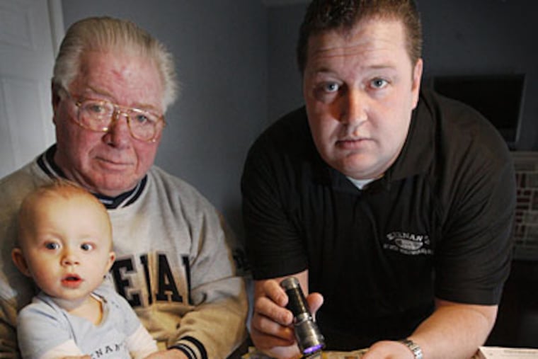 Scott Keenan, his 10-month-old son Jack, and his father, Jack. The family owns Keenan's a North Wildwood bar recently shut for serving underage people. (Alejandro A. Alvarez / Staff)